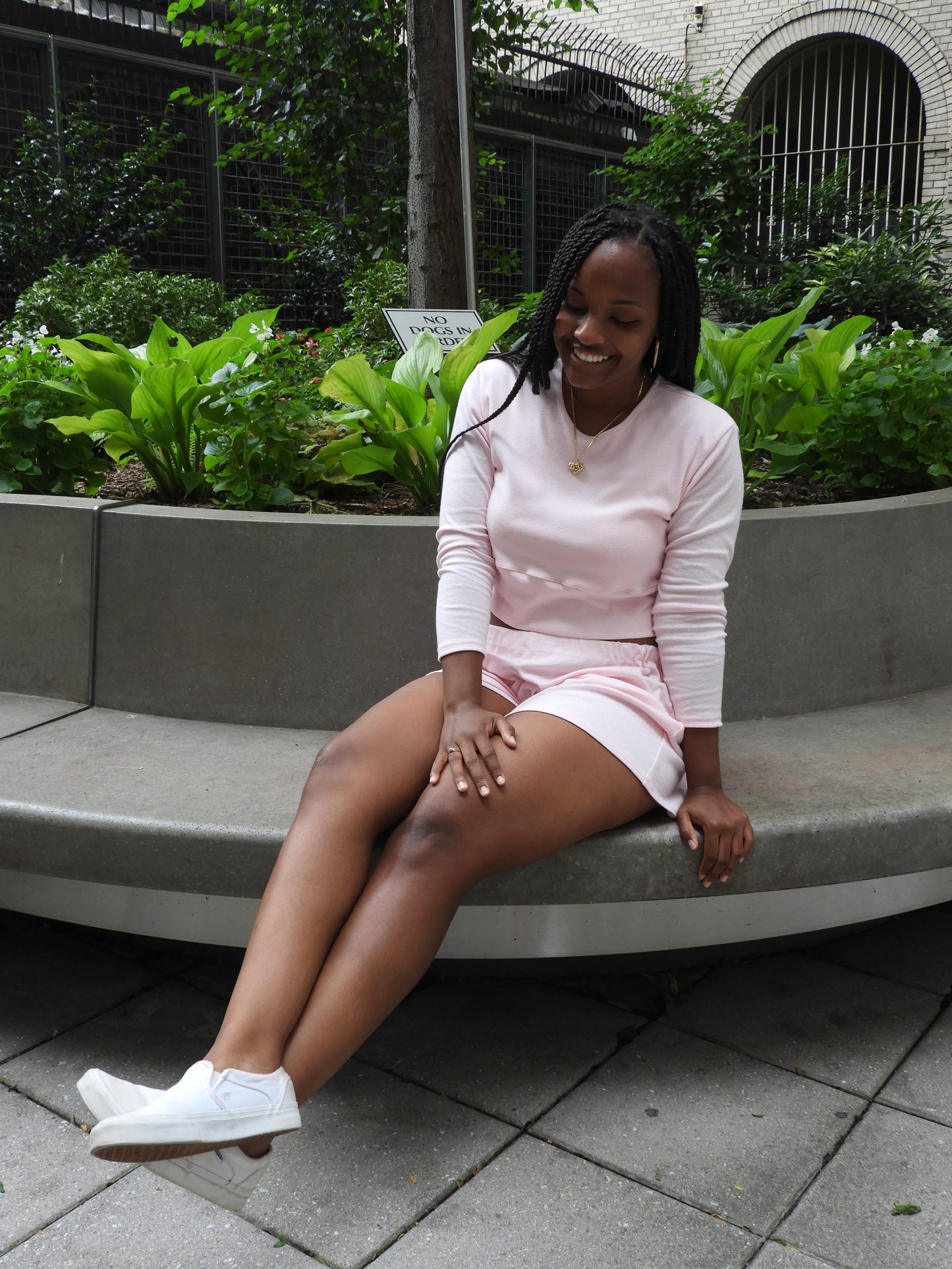 Pink soft long sleeve crop top with a cutout in the back.