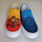 Slip on orange ombre right sneaker with sun god petroglyph symbol. Left blue ombre sneaker with moon goddess symbol.